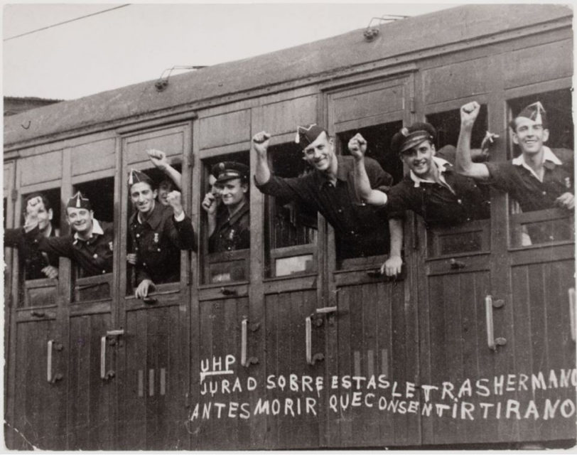 Robert Capa, [Republican soldiers saluting through the windows of their departing train, Barcelona, Spain], August 1936. The Robert Capa and Cornell Capa Archive, Gift of Cornell and Edith Capa, 2010 (2010.86.16)