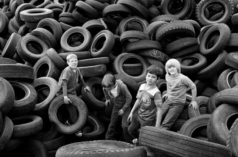 Mimi Plumb (American, born 1953), "Boys and Tires, Sears Point", 1976, pigmented inkjet print, High Museum of Art, Atlanta, Gift of Lucas Foglia. 2025.87. © Mimi Plumb.