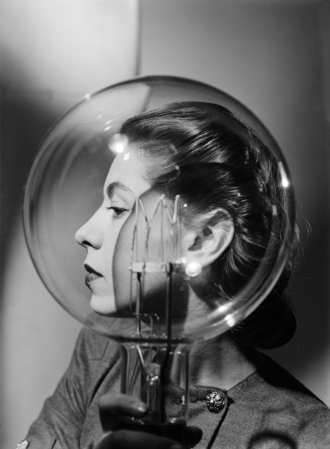 Lee Miller, Model with lightbulb, Vogue Studio, London, England c.1943  © Lee Miller Archives, England 2024. All rights reserved. leemiller.co.uk