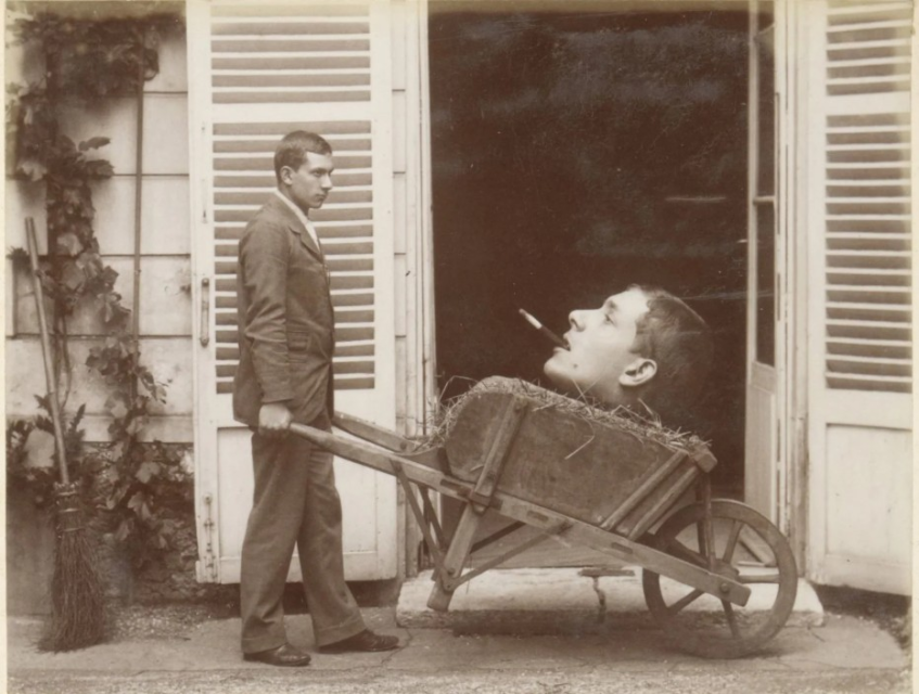 Man Carries (Mounted) Head on Wheelbarrow - c. 1910