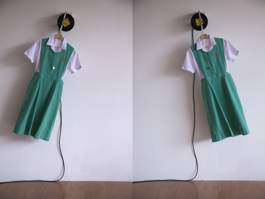 Leung Chi Wo A Countess From Hong Kong 2016 Belilios Public School uniform, cloth hanger, 1967 Hong Kong 50-cent coins, vinyl record This Is My Song by Petula Clark (1967), motor system 134 x 68 x 19 cm (Still)