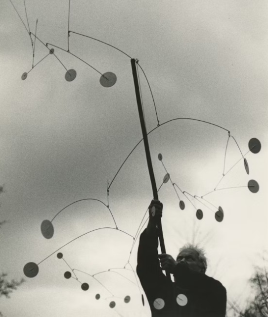 Ugo Mulas, Calder with "Snow Fury" (1948), Saché, 1963. © 2026 Calder Foundation, New York / ADAGP, Paris. Photo courtesy of Calder Foundation, New York / Art Resource, New York. Photograp by Ugo Mulas. © Ugo Mulas Heirs