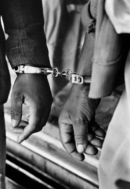 ERNEST COLE, Handcuffed blacks were arrested for being in a white area illegally, South Africa, 1960's.- Courtesy of the artist and KYOTOGRAPHIE (Kyoto International Photography Festival). In collaboration with Magnum Photos.